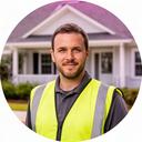 Local roofing company owner in a safety vest outside a Charleston home